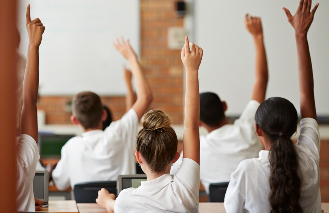 Photo of students raising their hand